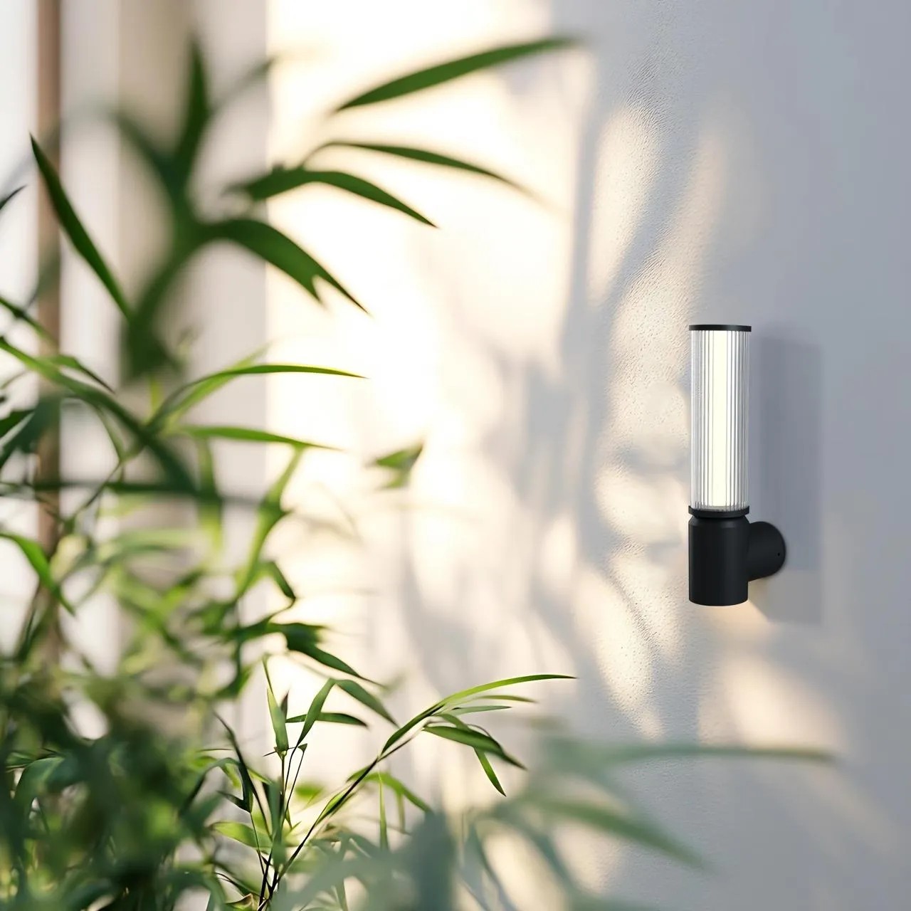 Fluted cylindrical wall light mounted on a white exterior wall